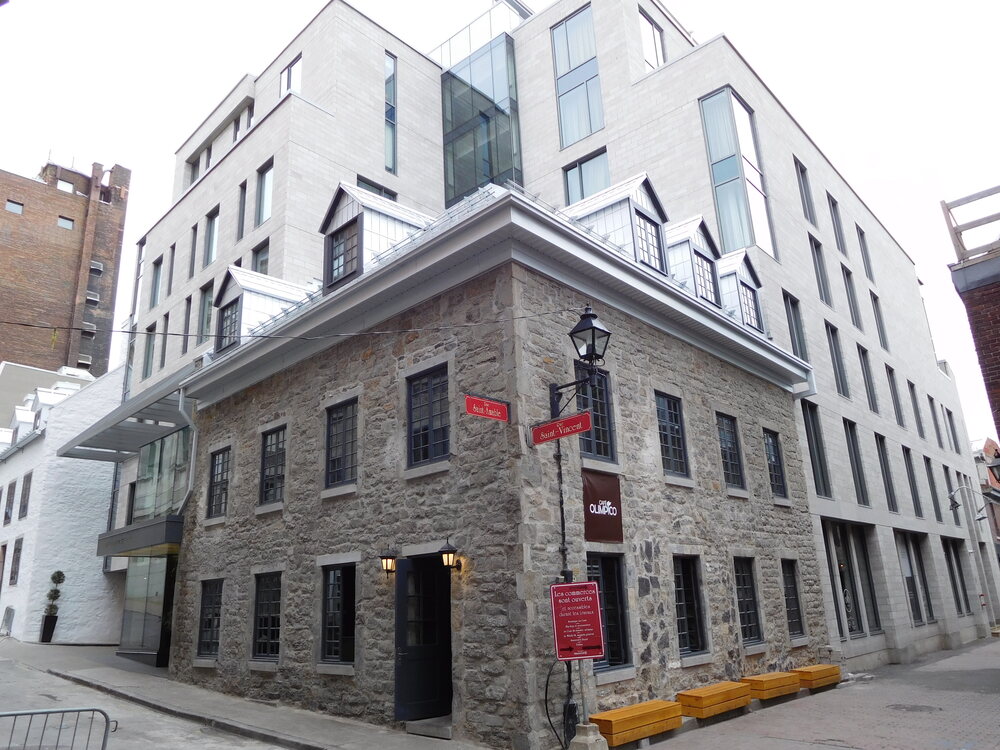 The William Gray boutique hotel — heritage stone and modern glass on a cobblestone corner in Old Montreal.